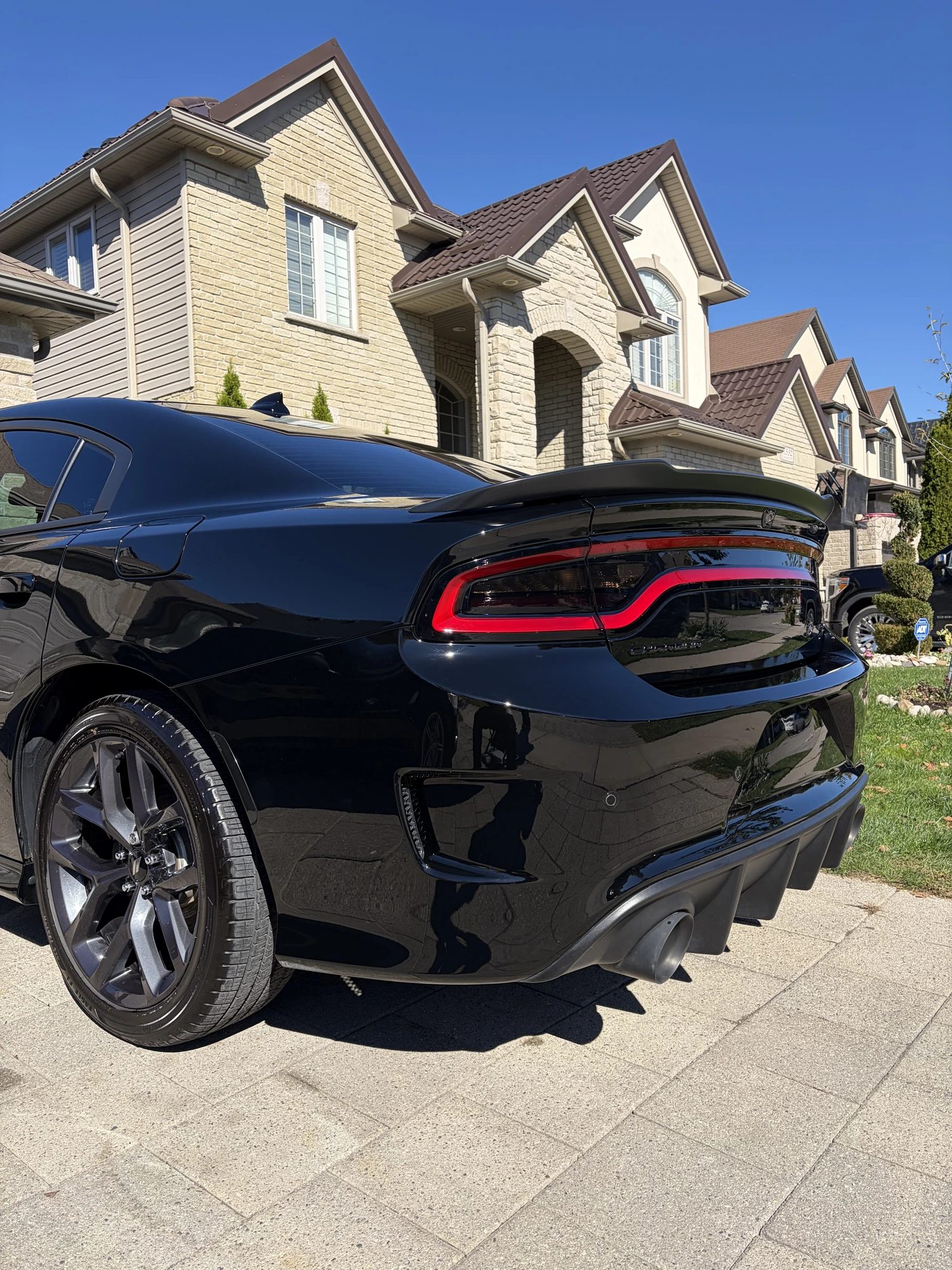 Black Dodge Charger R/T with mirror-deep reflections after an exterior detail by Unreal Auto Spa